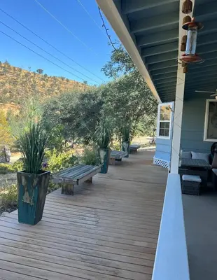 a porch with benches on the side of a house at Mountain View Home in Kernville
