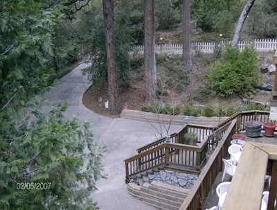 an outdoor patio with stairs and tables and trees at McCaffrey House Bed and Breakfast Inn in Twain Harte