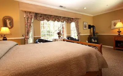 a bedroom with a large bed and a window at McCaffrey House Bed and Breakfast Inn in Twain Harte