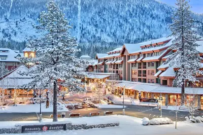 a resort in the snow with snow covered trees at Luxury 4BDR Residence steps from Heavenly Village condo in South Lake Tahoe