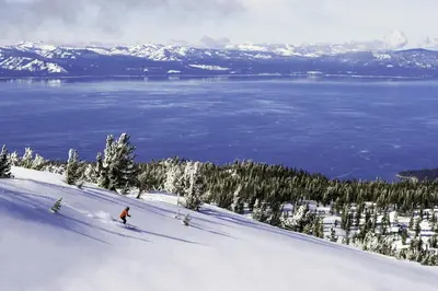 a person is skiing down a snow covered slope at Luxury 4BDR Residence steps from Heavenly Village condo in South Lake Tahoe