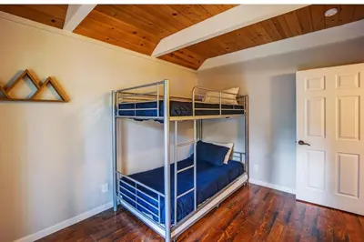 a bedroom with bunk beds in a room with a wooden ceiling at Hot tub - Play structure - Mini pool table game in South Lake Tahoe