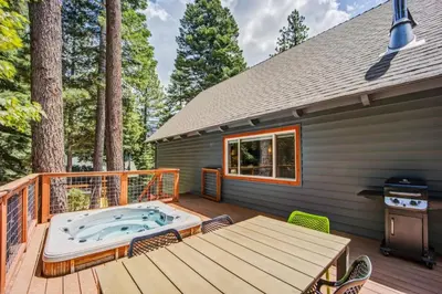 a hot tub on the deck of a house at Hot tub - Play structure - Mini pool table game in South Lake Tahoe