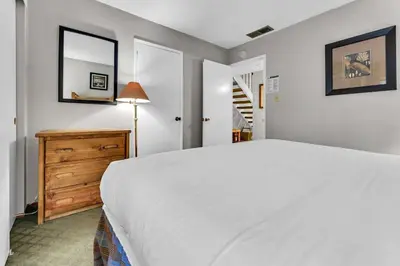 a bedroom with a white bed and a dresser and a mirror at Carnelian Bay 2BR + Loft Near Beach & Trails in Carnelian Bay