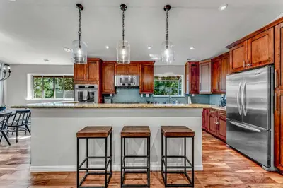a kitchen with wooden cabinets and stainless steel appliances at Charming Tahoe Cabin with Private Beach Access in Tahoe City
