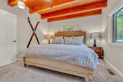 a bedroom with a large bed and a wooden ceiling at Charming Tahoe Cabin with Private Beach Access in Tahoe City