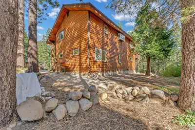 a log cabin in the woods with trees at Charming Tahoe Cabin with Private Beach Access in Tahoe City