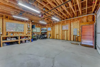 a large room with wooden walls and a garage at Charming Tahoe Cabin with Private Beach Access in Tahoe City