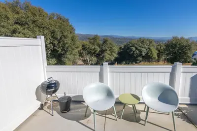 a group of chairs and tables on a patio at Creature Comforts Suite-Private Hot Tub-Sleeps 2 in Ahwahnee