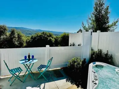a table and chairs next to a swimming pool at Creature Comforts Suite-Private Hot Tub-Sleeps 2 in Ahwahnee