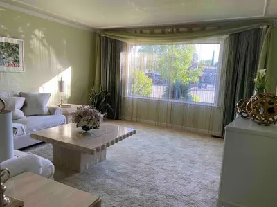 a living room with a couch and a large window at Redwood Garden in Sacramento