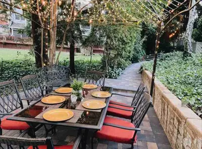 a wooden table with chairs and plates on it at Redwood Garden in Sacramento