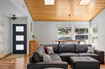 a living room with a couch and a wooden ceiling at Peaceful Creekside Buddha Retreat in Groveland