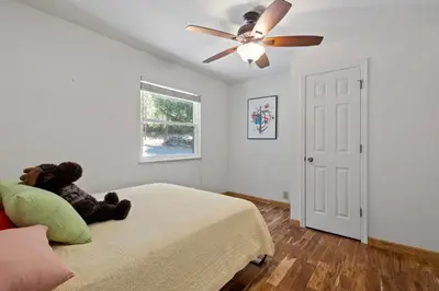 a teddy bear sitting on a bed in a bedroom at Peaceful Creekside Buddha Retreat in Groveland