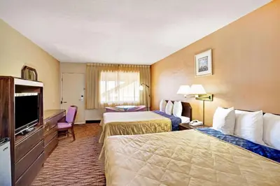 a hotel room with two beds and a flat screen tv at Howard Johnson by Wyndham South Lake Tahoe in Bijou