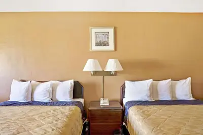 a hotel room with two beds with white pillows at Howard Johnson by Wyndham South Lake Tahoe in Bijou