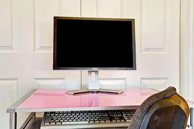 a computer monitor and a keyboard on a desk at Howard Johnson by Wyndham South Lake Tahoe in Bijou