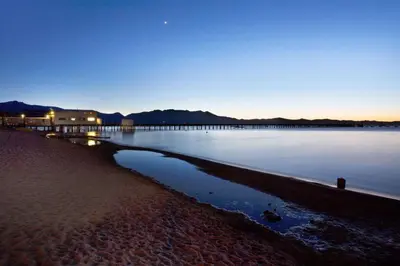 a large body of water with a pier in the background at Howard Johnson by Wyndham South Lake Tahoe in Bijou