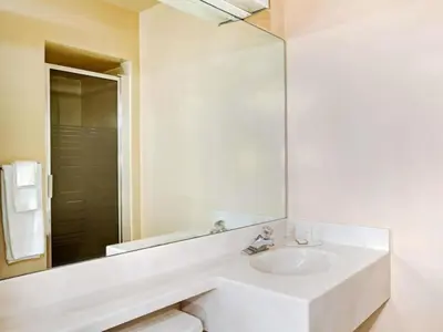 a white bathroom with a sink and a mirror at Howard Johnson by Wyndham South Lake Tahoe in Bijou