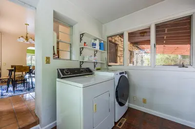 a kitchen with a washer and dryer in a room at Cozy 2BR Home Near UNR with Large Deck & Parking in Reno