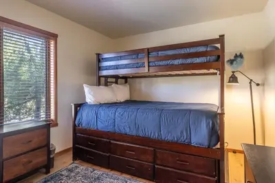 a bedroom with two bunk beds and a desk at Snowcreek #793 Phase V - 3 Bedroom 3 Bath Sleeps 8 with Private 1 Car Garage in Mammoth Lakes