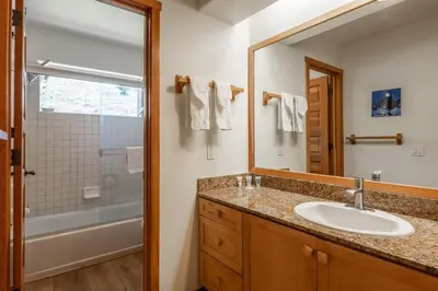 a bathroom with a sink and a mirror and a shower at Snowcreek #793 Phase V - 3 Bedroom 3 Bath Sleeps 8 with Private 1 Car Garage in Mammoth Lakes