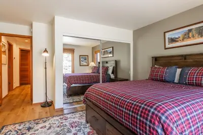a bedroom with two beds and a mirror at Snowcreek #793 Phase V - 3 Bedroom 3 Bath Sleeps 8 with Private 1 Car Garage in Mammoth Lakes
