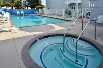 a large swimming pool with stairs in the middle at Best Western Executive Inn in Los Banos