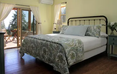 a bedroom with a bed and a balcony at Courtwood Inn in Murphys