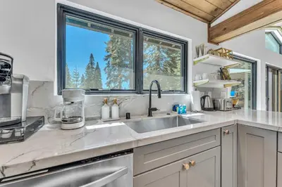 a kitchen with a sink and a window at Modern Mountain Luxury Retreat, Hot Tub & Grill in Carnelian Bay