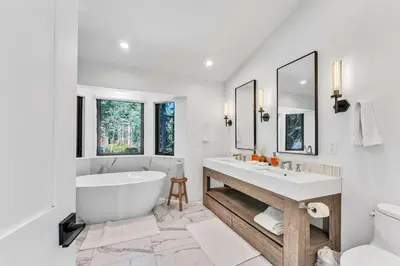 a white bathroom with a tub and a sink at Modern Mountain Luxury Retreat, Hot Tub & Grill in Carnelian Bay