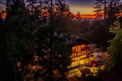 a house is lit up at night with lights at Sunset Summit Villa 2 min from Bass Lake in Bass Lake