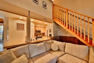 a living room with a couch and a staircase at The Pad at South Lake Tahoe in Bijou Park