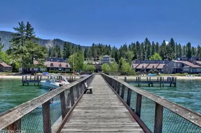 a wooden dock with a boat on the water at The Pad at South Lake Tahoe in Bijou Park
