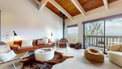 a living room with a couch and a table at Mammoth Point #117 condo in Mammoth Lakes
