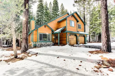 a log cabin in the woods in the snow at The Gathering Place in Truckee