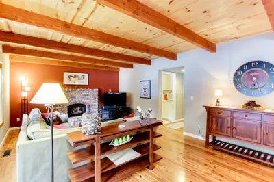 a living room with a couch and a fireplace at The Gathering Place in Truckee