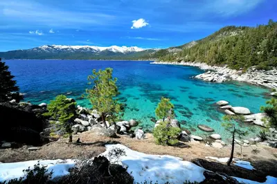 a large body of water with mountains in the background at The Gathering Place in Truckee