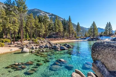 a pool of water with rocks in a river at Cozy and central Tahoe cabin with private hot-tub outdoor fireplaces close to slopes in Ridgewood