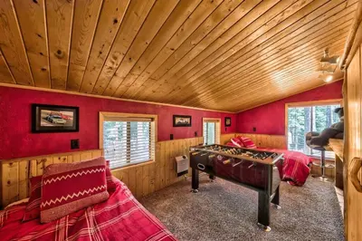 a bedroom with red walls and a wooden ceiling at Cozy and central Tahoe cabin with private hot-tub outdoor fireplaces close to slopes in Ridgewood