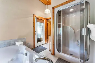 a bathroom with a shower and a white tub at Northstar Retreat by Golf Course & Free Shuttle in Truckee