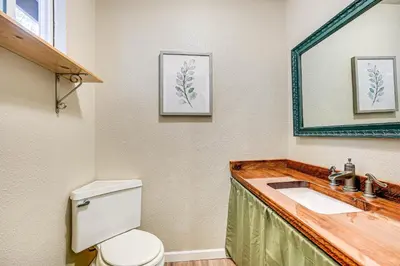 a bathroom with a toilet and a sink at Mtn-View Gem Deck, Grill and Fire Pit in West Point in Volcano