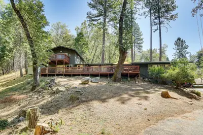 a house with a deck in the woods at Mtn-View Gem Deck, Grill and Fire Pit in West Point in Volcano