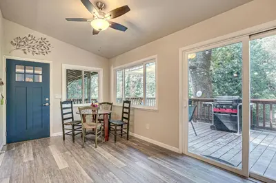 a dining room with a table and chairs and a ceiling fan at Mtn-View Gem Deck, Grill and Fire Pit in West Point in Volcano