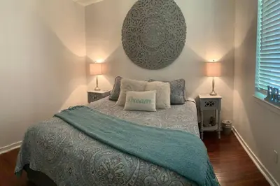 a bedroom with a bed with a blue blanket and two lamps at Walnut Grove 2BD 1Bath in Oakhurst