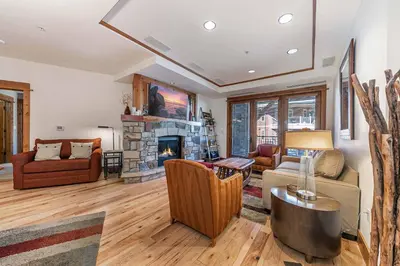 a living room with a couch and a fireplace at Big Horn Lodge 307 by East West Hospitality in Truckee