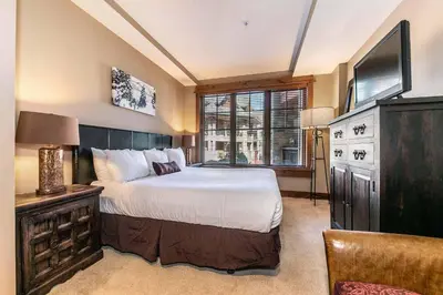 a bedroom with a large bed and a television at Big Horn Lodge 307 by East West Hospitality in Truckee
