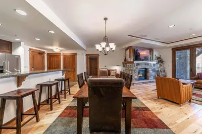 a kitchen and dining room with a table and chairs at Big Horn Lodge 307 by East West Hospitality in Truckee