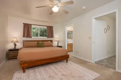 a bedroom with a bed and a ceiling fan at Bald Bear Barracks in Mariposa