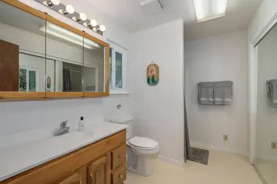 a bathroom with a sink and a toilet and a mirror at Bald Bear Barracks in Mariposa